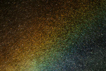 mist from a waterfall catches the light and explodes in a prism of color, Honduras.