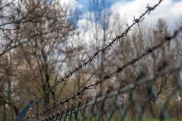 barbed wire fence and metal bar fencing