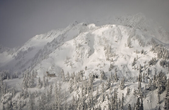 A winter storm breaks long enough to see the top of Pan Dome and Mount Herman beyond from chair at Mount Baker Ski Area.