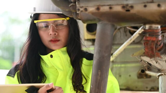 Technician fixing the engine of the airplane,Female aerospace engineering checking aircraft engines,Asian mechanic maintenance inspects plane engine