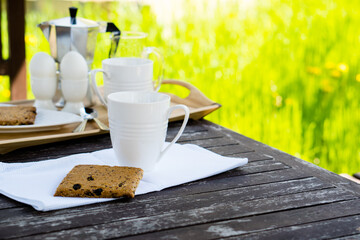 Breakfast for two on an old table in the summer garden