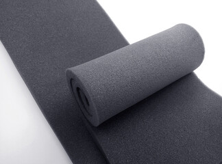 two sheets of black spongy foam material on a white background