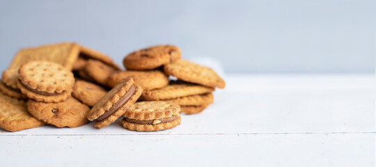 Different biscuits on wood background in the morning. Copy space