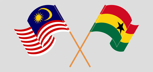 Crossed and waving flags of Malaysia and Ghana