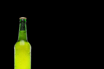 Green beer bottle isolated on black background. Place for text. Copy