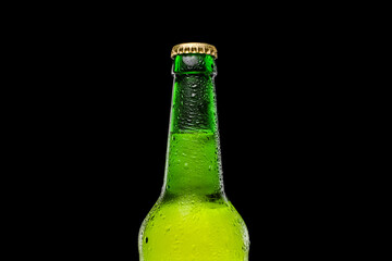 Green beer bottle on black background. Cold and refreshing beer