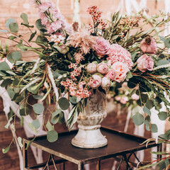 Wedding arrangement of natural flowers in boho style.