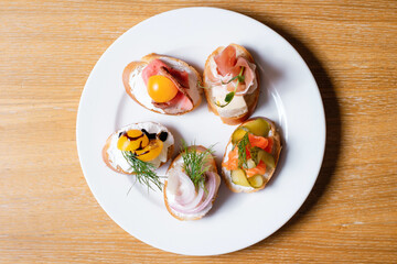 Bruschet set with ham, cheese, vegetables. Snack with salmon, tomato and cucumber.