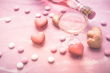 Happy Mothers Day - sweet macarons in heart shape and glass of rose sparkling wine