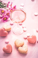 Happy Mothers Day - sweet macarons in heart shape and glass of rose sparkling wine