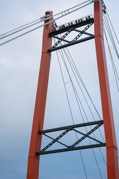 The orange masts of the cable-stayed bridge. Bottom perspective.