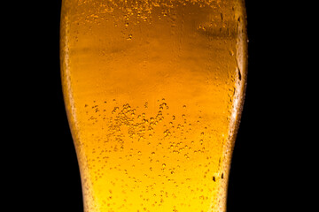 Cold Light Beer in a glass with water drops. Close up.