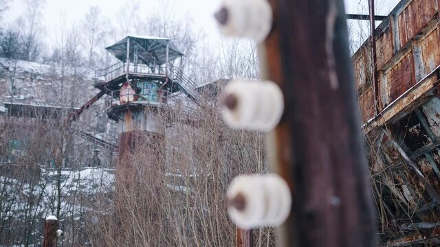 Closeup view of the electric fence poles in the Liban quarry which has served as the film set for Schindler's List. Plaszow concentration camp in the city of Krakow Poland. Light snowfall. 