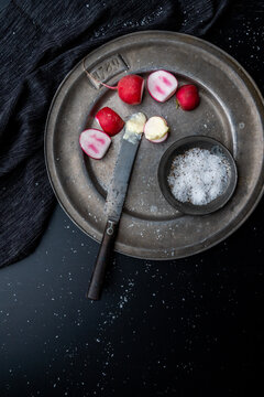 Radishes on pewter plate