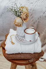 Still life concept, hygge style - cup of coffee, decorative dried flowers in vase. Warm cozy composition.