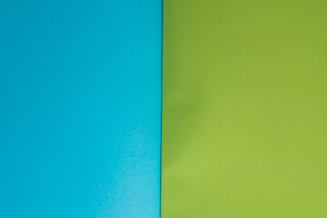 Obraz premium vivid blue and green paper bound together - vertical line