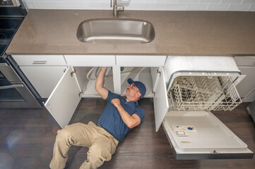 Appliance technician installing a dishwasher