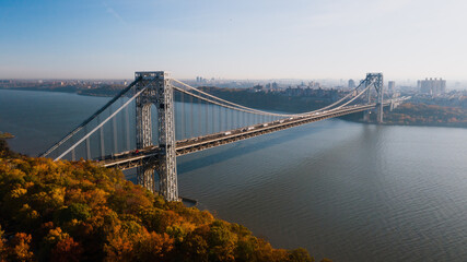 Aerial of George Washington Suspension Bridge over Hudson River at Autumn Sunrise - Interstate 95, US Route 1 & 9 - Fort Lee, New Jersey & Bronx, New York City, New York