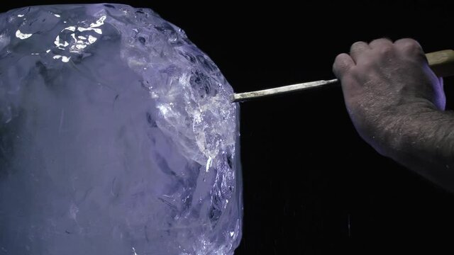 Creation of an ice sculpture in the studio using a chisel and hammer, 4k