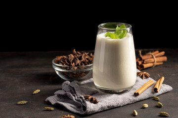lassi, lassie - indian yogurt drink with spice on dark background