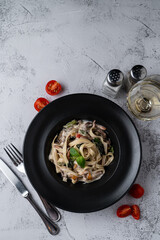 Directly above shot of italian pasta on grey stone background, minimalist shot