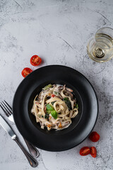 Directly above shot of italian pasta on grey stone background, minimalist shot