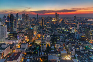 Fototapeta premium Sunset panorama aerial view in the middle of Bangkok cityscape skyline .Night scene before sunrise , Thailand.