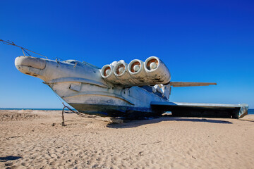 Fototapeta na wymiar Abandoned Soviet Lun-class ekranoplan on the coast of the Caspian Sea