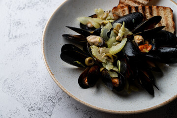 A portion of missiles with olives with fragrant melted butter and a glass of white wine, italian restaurant meal