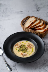Cheese creamy soup with fettuccine and grated pistachios, top view