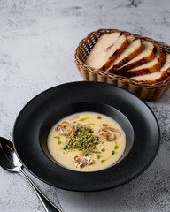 Cheese creamy soup with fettuccine and grated pistachios, top view