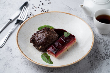 Sous vide beef cheeks garnished with beetroot and potato, side view