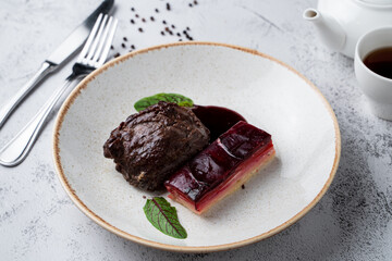 Sous vide beef cheeks garnished with beetroot and potato, side view