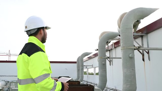 Air conditioning technicians repair and maintain condensing units outside the building, engineers inspect the operation of ventilation fans.