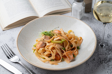 Salmon, caviar and avocado fettuccine on a side dish in an italian restaurant