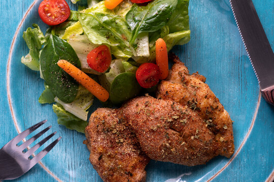 Roasted chicken thigh with zafrani rice and salad