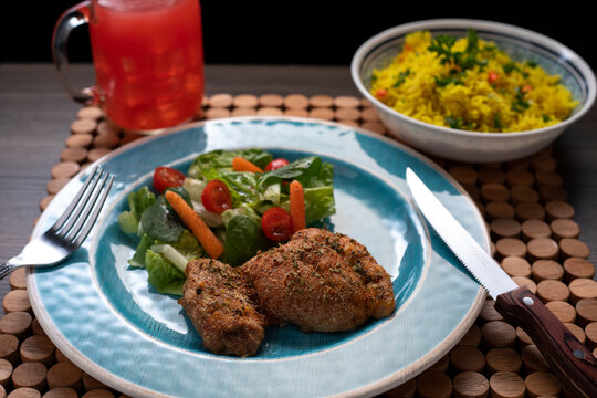Roasted chicken thigh with zafrani rice and salad