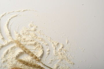 Flour, wheat, rice, raisins and coins on a white background