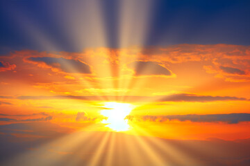 Fototapeta premium Spectacular orange sky with sun rays in the evening . Sunset with dark blue clouds