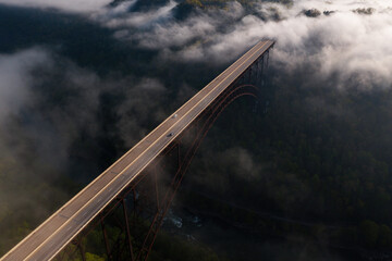 Aerial of New River Gorge Bridge on Foggy Spring Morning - US Route 19 / Corridor L - New River Gorge National Park & Preserve - West Virginia