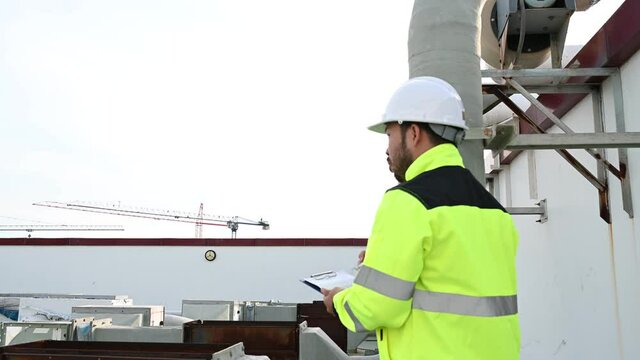 Air conditioning technicians repair and maintain condensing units outside the building, engineers inspect the operation of ventilation fans.
