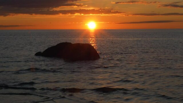 Big rock and the sea, during a warm, summer sunset, in Kalajoki, Finland