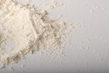 Flour, wheat, rice, raisins and coins on a white background