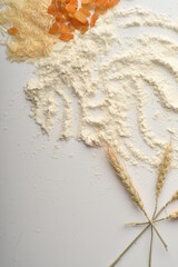 Flour, wheat, rice, raisins and coins on a white background