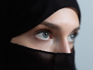 Portrait of muslim woman wearing niqab and traditional arabic clothes or abaya