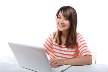 Young Japanese female student operating a personal computer 