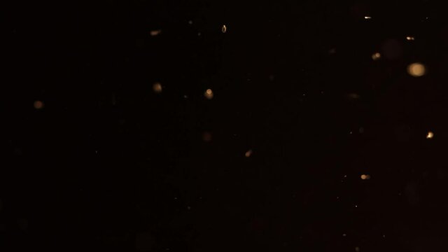 Flickering golden bokeh balls in 4k for film overlay.