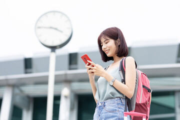 Asian traveler use smartphone