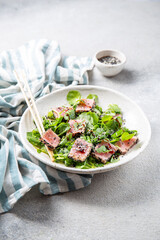 Japanese sliced grilled tuna steak salad with sesame and suace. Close up