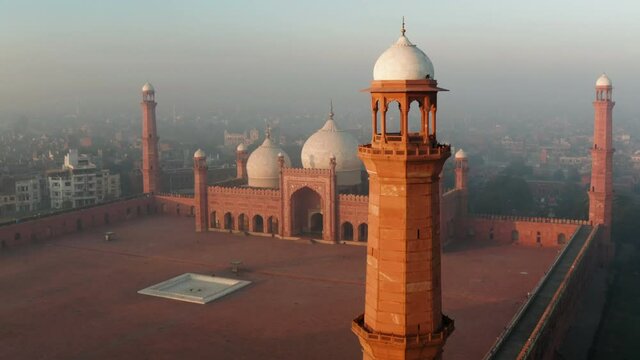 Minaret Of Badshahi Mosque Lahore, Pakistan Against Overcast Sky. - Aerial Shot